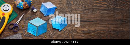 Diamonds stitched in the form of a cube. The process of sewing a quilt. Stock Photo