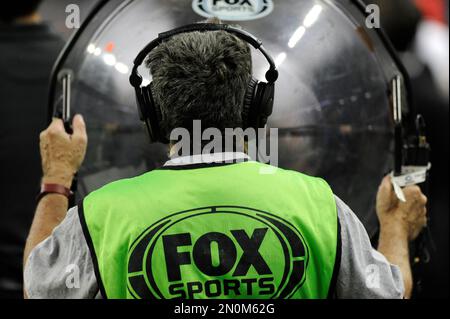 A FOX Sports employee holds a sound dish on the sideline during an