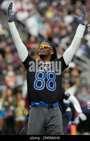 NFC wide receiver CeeDee Lamb of the Dallas Cowboys tosses a ball to a  teammate during Pro Bowl NFL football practice, Friday, February 4, 2022,  in Las Vegas. (Gregory Payan/AP Images for