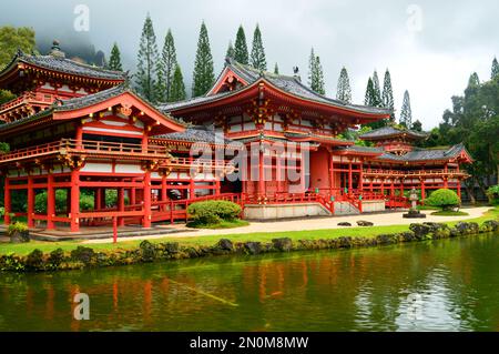 The Byodo In Buddhist temple, sits in a lush and foggy valley in Hawaii Stock Photo