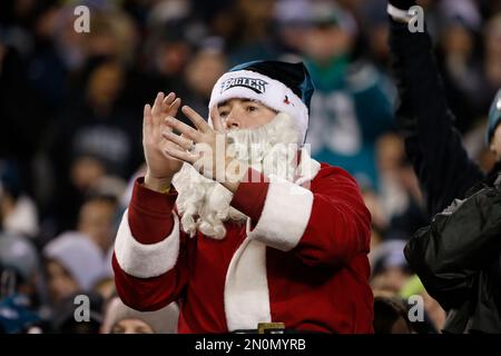 An Arizona Cardinals fan, dressed as Santa Claus, cheers during the first  half of an NFL football game against the Indianapolis Colts, Saturday, Dec.  25, 2021, in Glendale, Ariz. (AP Photo/Rick Scuteri