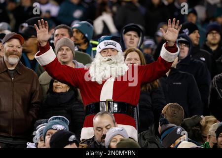 An Arizona Cardinals fan, dressed as Santa Claus, cheers during the first  half of an NFL football game against the Indianapolis Colts, Saturday, Dec.  25, 2021, in Glendale, Ariz. (AP Photo/Rick Scuteri