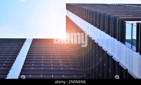 Bottom view of modern skyscrapers in business district against blue sky. Looking up at business buildings in downtown. Stock Photo