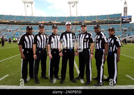 Game officials pose on the field before an NFL football game between the Minnesota  Vikings and the Chicago Bears, Sunday, Dec. 30, 2018, in Minneapolis. Shown  are replay assistant Willie Vizoso, from