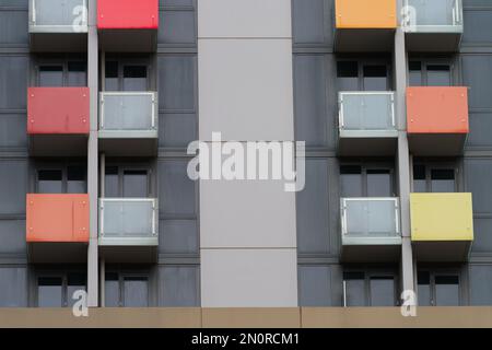 Apartment building exterior view with multi colour balconies and a background concrete texture, Melbourne Australia. Stock Photo