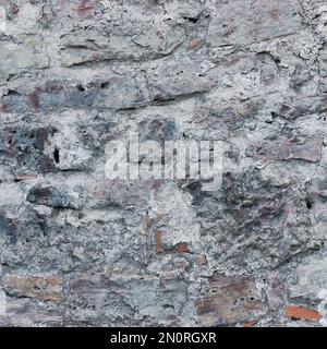 Stone wall background closeup, horizontal plastered grunge red grey beige stonewall limestone pattern, old aged weathered gray lime plaster texture Stock Photo