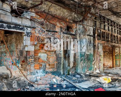 A view through an empty door into an abandoned automotive factory in Detroit. Stock Photo
