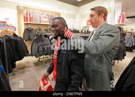 IMAGE DISTRIBUTED FOR JCPENNEY - Dallas Cowboys linebacker Sean Lee, left,  shops alongside Ajion Lair, 18, from the Boys & Girls Club of Greater Dallas  as he selects gifts for his family