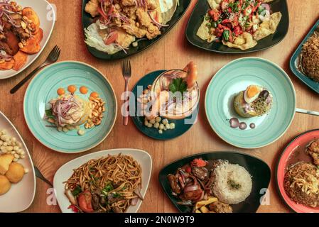 Set of typical Peruvian food recipes, anticuchos, fish jelly, lomo saltado, arroz chaufa, causa lima, salted noodles, rice and leche de tigre Stock Photo