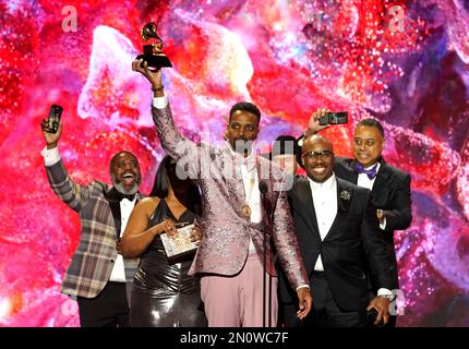 J. Ivy, center, accepts the award for best spoken word poetry album for