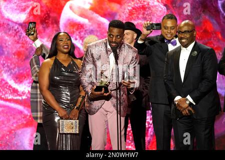 J. Ivy, center, accepts the award for best spoken word poetry album for