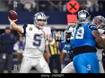 Tony Romo of the Dallas Cowboys holds the ball under pressure from