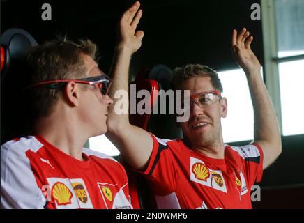 Ferrari driver Sebastian Vettel of Germany right gestures with his