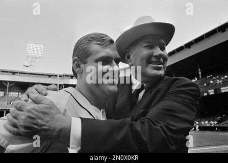 Detroit Tigers ace pitcher Denny McLain holds a plastic chicken under his  arm as he signs an autograph for nurse J. Adams, shortly before he performs  an organ recital at a downtown