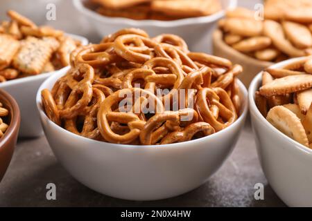Delicious crackers in bowls on table, closeup Stock Photo