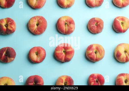 Fresh donut peaches on light blue background, flat lay Stock Photo