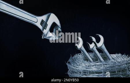 metal locksmith wrenches and nuts with barbed wire Stock Photo