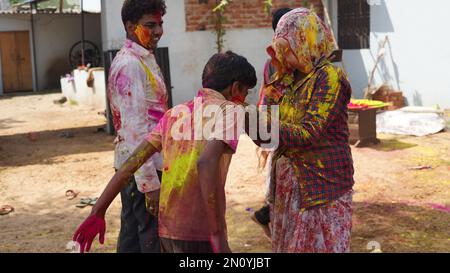 05 February 2023 Jaipur, Rajasthan, India. Happy Mother enjoying time with her son during holi festival at home Stock Photo