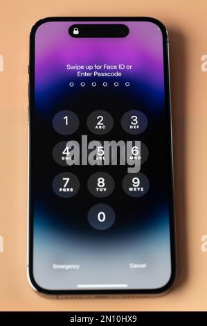 New york, USA - January 28, 2022: Enter passcode or use face id on iphone 14 pro in smartphone screen close up view Stock Photo