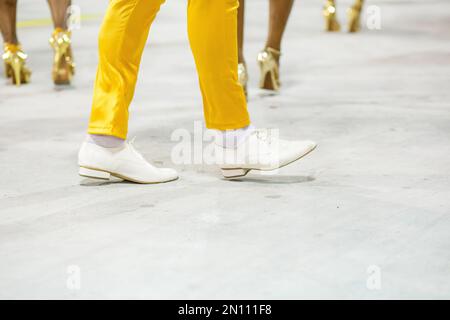 legs of a sambista dancing, with yellow pants and white shoes at the sambodromo da marques de sapucai in Rio de Janeiro, Brazil. Stock Photo