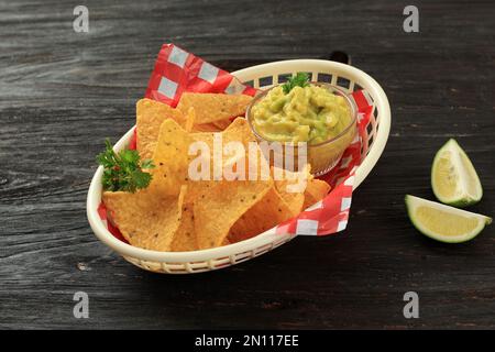 Nachos Tortilla Chips with Guacamole Avocade Lime Dipping Sauce. On Wooden Table Stock Photo