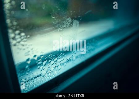 Drops of condensation on the window close-up. Humidity and temperature difference between the street and the room Stock Photo