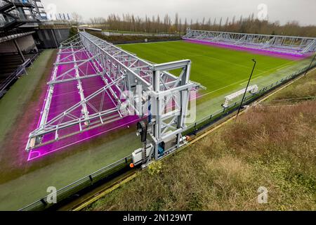 Fully automatic movable LED lighting system for turf growth lighting of stadium driven turf football pitch playing field of Bundesliga club football c Stock Photo