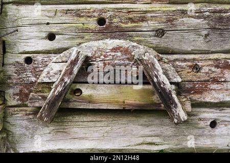 Old traditionlan device to bend poles and planks on barn wall Stock Photo