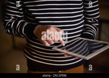 Using touchscreen technology. a hipster using a touchscreen device. Stock Photo