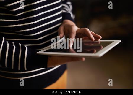Using touchscreen technology. a hipster using a touchscreen device. Stock Photo