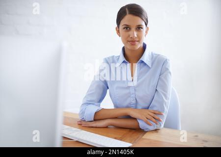 Serious about success. Portrait of a successful young businesswoman at her office desk. Stock Photo