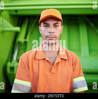 Garbage collection day. Cropped portrait of a garbage collection worker standing by a garbage truck. Stock Photo