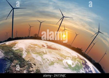 Field of wind turbines on the earth at sunset To produce clean, environmentally friendly and sustainable electricity Stock Photo