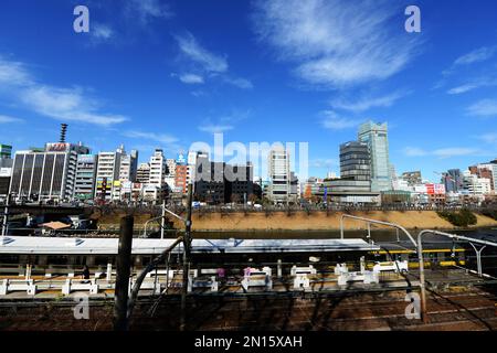 A view of the changing skyline in Ichigaya along the Imperial palace outer moat and the JR Chou line. Tokyo, Japan. Stock Photo