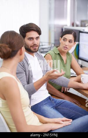 Next generation techies. a young businessman explaining something to his colleagues. Stock Photo
