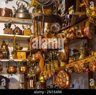 The metal utensils made up of copper and brass. Teapots, cups, lamps, jugs, made of gold, brass, handmade silver Stock Photo