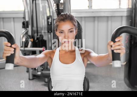 Woman trains pecs in the gym Stock Photo by ©kopitin 93164030