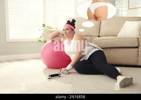 Overweight woman dreaming about slim body while having break in training. Weight loss concept Stock Photo