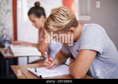 Hes totally focused. a group of university students studying together. Stock Photo