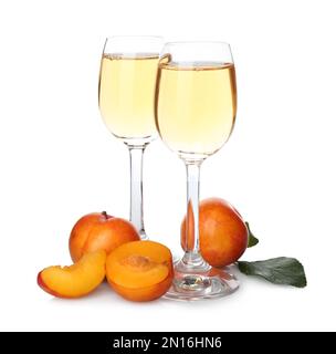 Delicious plum liquor and ripe fruits on white background. Homemade strong alcoholic beverage Stock Photo
