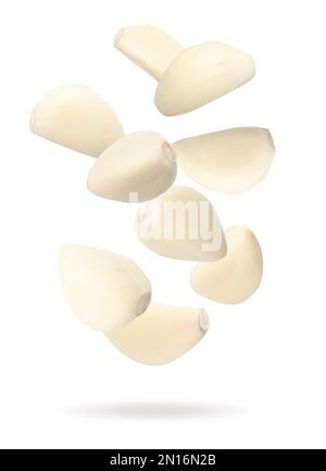Falling peeled garlic cloves isolated on white background with clipping ...