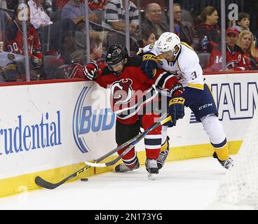 New Jersey Devils forward Kyle Palmieri (21) checks Tampa Bay