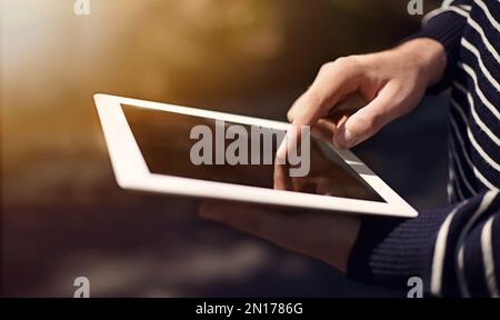 Get in touch with your technology. a man using a digital tablet. Stock Photo