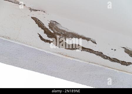 Due to the humidity, the plaster and paints on the ceiling of the balcony were peeled off Stock Photo