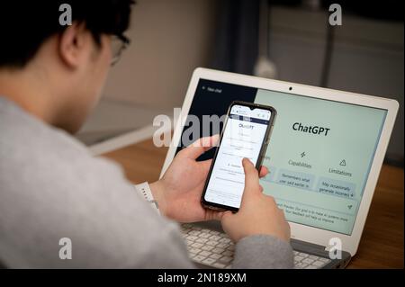 Seoul, South Korea - February 06, 2023 : A man looking for information using artificial intelligence ChatGPT Stock Photo