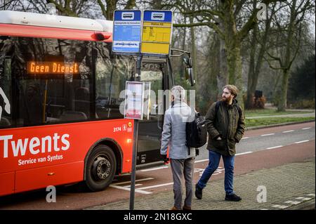 HENGELO - A bus passes waiting travelers at Delden station during a strike of regional transport and regional transport. Due to the strike, there are fewer or no buses outside the major cities. Trains from companies other than NS also do not run or run less often. With the strike, the employees are trying to reinforce their demands for better working conditions, including higher wages.ANP EMIEL MUIJDERMAN netherlands out - belgium out Stock Photo