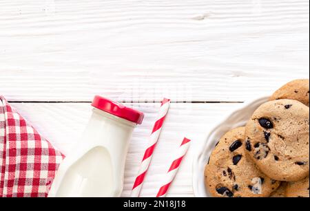 Small glass milk bottle with pink candy stripe paper straws and pink  macarons Stock Photo - Alamy