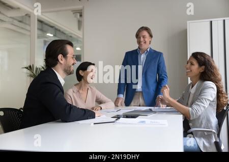 Successful business team brainstorming on project on meeting, enjoying success, Stock Photo