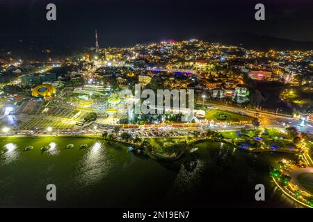 Aerial panorama view of Sunflower Building at night in Da Lat City. Tourist city in developed Vietnam. Center Square of Da Lat city with Xuan Huong Stock Photo