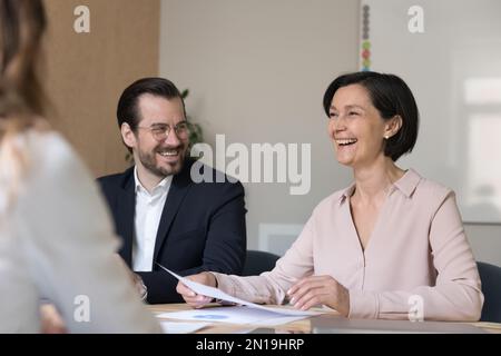 Happy cheerful mature business woman telling funny creative idea Stock Photo
